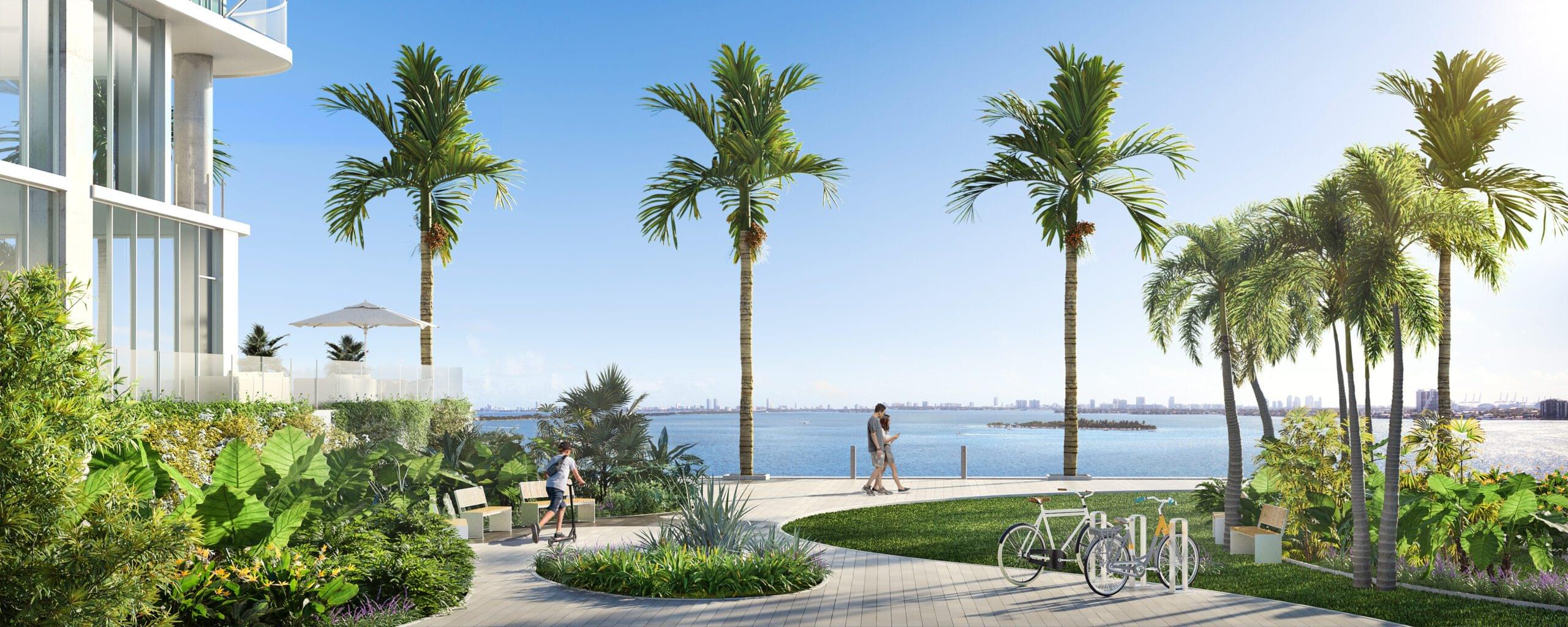 Baywalk with palm trees near the waterfront, featuring the Aria Reserve Residences building on the left.